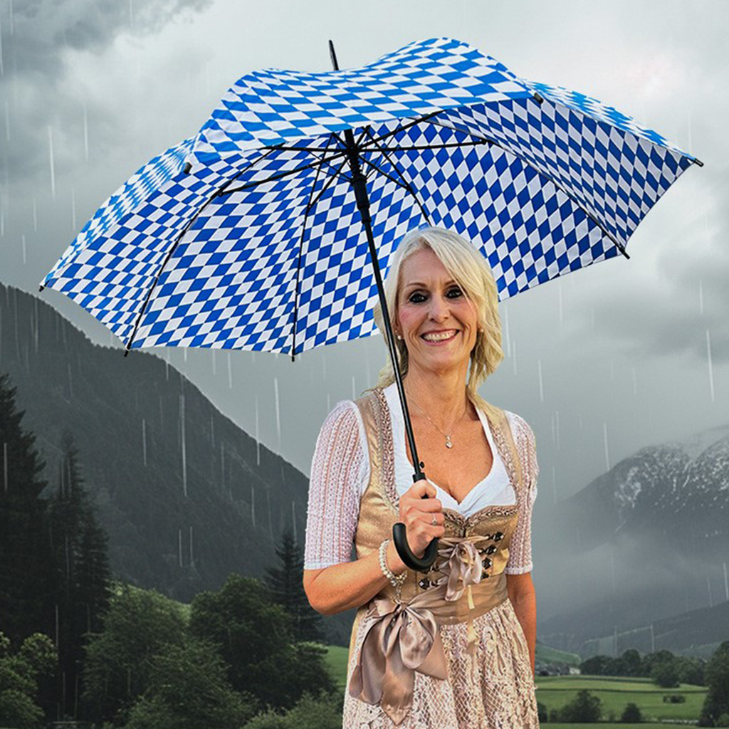 Woman in dirndl with rhombus umbrella