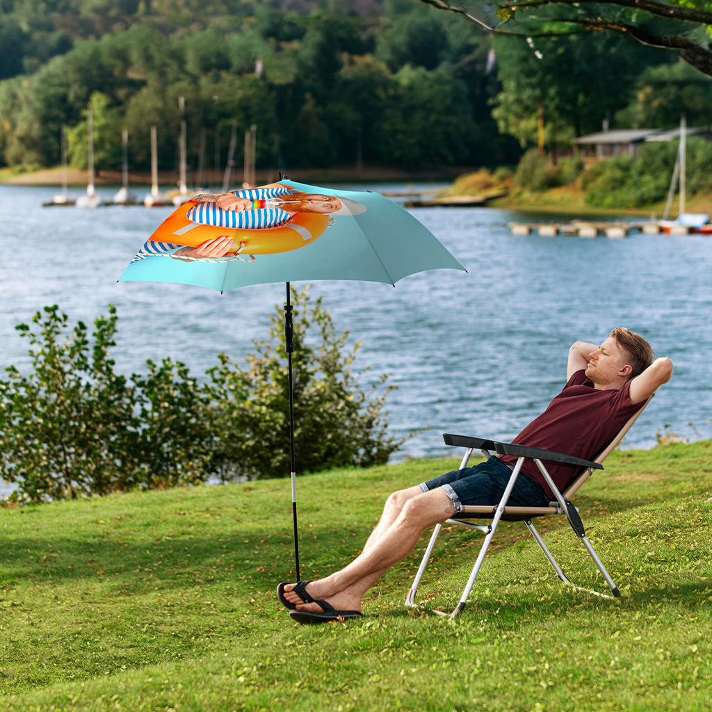 Man at the lake under a parasol, Travelmate camper van