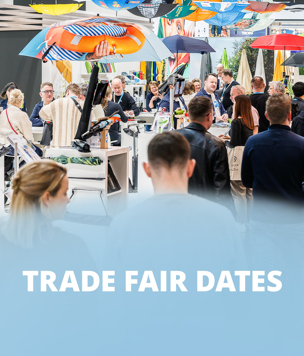 FARE trade fair booth with visitors, colorful umbrellas suspended above, and the text 'Trade Fair Dates' on a blue-white background.